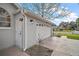 Garage with an adjacent exterior door and an inviting blue sky in the background at 19215 Park Place Blvd, Eustis, FL 32736