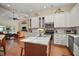 Bright kitchen with stainless steel appliances, white cabinets, a center island, and hardwood floors at 19215 Park Place Blvd, Eustis, FL 32736