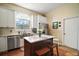 Bright kitchen featuring stainless steel appliances, island with seating, white cabinets, and hardwood floors at 19215 Park Place Blvd, Eustis, FL 32736