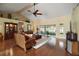 Cozy living room featuring hardwood floors, vaulted ceilings, a ceiling fan, and sliding glass doors at 19215 Park Place Blvd, Eustis, FL 32736