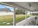 Covered patio featuring ceiling fans, tiled floor, and outdoor seating with views of the lush backyard at 19215 Park Place Blvd, Eustis, FL 32736