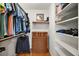 Organized closet with shelves, dresser, hanging rods, and hardwood flooring at 19215 Park Place Blvd, Eustis, FL 32736