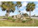 Linden Isle community sign surrounded by palm trees and lush landscaping on a bright day at 1930 Rhett Rd, The Villages, FL 32163