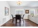 Cozy dining area featuring hardwood floors, a chandelier, and sliding glass doors at 1930 Rhett Rd, The Villages, FL 32163