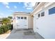 This home's exterior features a two-car garage with durable vinyl siding and carriage house doors at 1930 Rhett Rd, The Villages, FL 32163