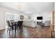 Bright and airy living room with wood floors, a ceiling fan, and large sliding glass doors at 1930 Rhett Rd, The Villages, FL 32163