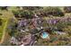 Aerial view of community homes featuring a swimming pool and proximity to a golf course at 202 Camino Real Blvd # 202, Howey In The Hills, FL 34737