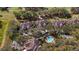 Aerial view of community homes featuring a swimming pool and proximity to a golf course at 202 Camino Real Blvd # 202, Howey In The Hills, FL 34737