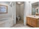 Bright bathroom featuring a soaking tub, a separate toilet room, and a vanity at 202 Camino Real Blvd # 202, Howey In The Hills, FL 34737