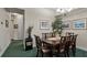 Formal dining room featuring a chandelier, wall art, and a wooden table with seating for six at 202 Camino Real Blvd # 202, Howey In The Hills, FL 34737