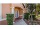 Welcoming entrance featuring classic columns, brick walkway, and manicured landscaping at 202 Camino Real Blvd # 202, Howey In The Hills, FL 34737