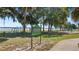 Griffin Park view of the lakefront park featuring exercise equipment and mature trees on a sunny day at 202 Camino Real Blvd # 202, Howey In The Hills, FL 34737