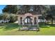 Lakeside outdoor area featuring a seating area with metal heron statue at the center, surrounded by serene lake views at 202 Camino Real Blvd # 202, Howey In The Hills, FL 34737