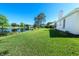 Expansive backyard with lush green lawn and peaceful pond at 2041 Park Forest Blvd, Mount Dora, FL 32757