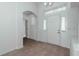 Inviting entryway featuring tile floors, an arched doorway, and a white front door at 2041 Park Forest Blvd, Mount Dora, FL 32757