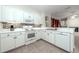 Well-equipped kitchen with white cabinets, stainless steel appliances, and a stylish backsplash at 2041 Park Forest Blvd, Mount Dora, FL 32757