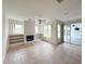 Spacious living room featuring a fireplace, built-in shelves, and sliding glass doors to the screened lanai at 2041 Park Forest Blvd, Mount Dora, FL 32757