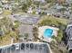 Overhead shot showcasing a community pool, clubhouse, tennis courts, and parking in a lush setting at 2130 Cascades Blvd # 101, Kissimmee, FL 34741