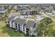 A high angle view of a complex featuring private balconies, parking, and beautiful landscaping at 2130 Cascades Blvd # 101, Kissimmee, FL 34741