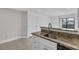 Kitchen area featuring stainless steel sink, tiled floors and granite countertops at 2130 Cascades Blvd # 101, Kissimmee, FL 34741