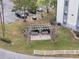 Overhead view of a cozy outdoor seating area with benches and a pergola in a well-maintained community at 2130 Cascades Blvd # 101, Kissimmee, FL 34741