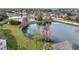 Scenic aerial view of a beautiful pond surrounded by lush greenery and charming community homes at 2130 Cascades Blvd # 101, Kissimmee, FL 34741