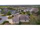 Aerial view of a home with screened in porch in a community with golf course and lake views at 2190 Derringer Ave, The Villages, FL 32162