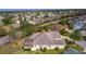 Image showing the property, screened in patio, large lawn, and nearby road, highlighting its accessible location at 2190 Derringer Ave, The Villages, FL 32162