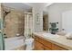 Bright bathroom with a shower-tub combination, single sink vanity and tiled floor at 2190 Derringer Ave, The Villages, FL 32162