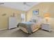 Cozy bedroom with neutral carpet, white furniture, and coastal decor at 2190 Derringer Ave, The Villages, FL 32162