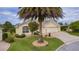 A well-maintained home with a mature palm tree and an inviting driveway at 2190 Derringer Ave, The Villages, FL 32162