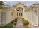 Inviting front entrance with decorative bushes lining the walkway at 2190 Derringer Ave, The Villages, FL 32162