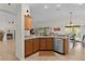 Open kitchen layout with stainless steel appliances, and a view to the breakfast nook at 2190 Derringer Ave, The Villages, FL 32162