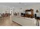 Bright living room featuring tile floors, neutral walls, and dining room with elegant chandelier at 2190 Derringer Ave, The Villages, FL 32162