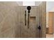 Tiled shower with shower head, controls and small storage niche at 2190 Derringer Ave, The Villages, FL 32162