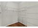 Large walk-in closet featuring white wire shelving and hardwood floors at 2190 Derringer Ave, The Villages, FL 32162