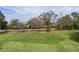 Well-maintained lawn with landscaping and an American flag in a residential neighborhood at 2190 Derringer Ave, The Villages, FL 32162