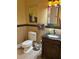 Cozy half-bath with decorative mirror, black granite sink, and a themed towel at 22244 County Road 455, Howey In The Hills, FL 34737