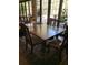 Dining room with hardwood table and chairs sitting on a beautiful rug, complemented by natural light from surrounding windows at 22244 County Road 455, Howey In The Hills, FL 34737