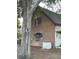 Brick house exterior featuring unique arched windows and a Generac whole-house generator at 22244 County Road 455, Howey In The Hills, FL 34737