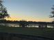 Scenic view of lake and gazebo at sunset at 22244 County Road 455, Howey In The Hills, FL 34737