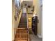 Traditional staircase with wooden banister and a display of framed art on the yellow wall at 22244 County Road 455, Howey In The Hills, FL 34737