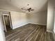 Spacious bedroom with wood-look tile flooring and a modern ceiling fan for added comfort at 2320 Whispering Trails Pl, Winter Haven, FL 33884