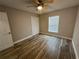 Bedroom with wood-look tile flooring, a ceiling fan, and natural light from the window at 2320 Whispering Trails Pl, Winter Haven, FL 33884