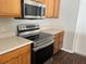 This kitchen features stainless steel appliances, wood cabinets, and laminate countertops at 2320 Whispering Trails Pl, Winter Haven, FL 33884