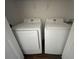 Laundry closet with Samsung washer and dryer, neutral walls and dark-wood look flooring at 2320 Whispering Trails Pl, Winter Haven, FL 33884