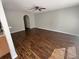 Open-concept living room with dark wood-look floors and neutral walls, next to kitchen at 2320 Whispering Trails Pl, Winter Haven, FL 33884