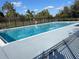 Community pool with fence and a safety ring, perfect for relaxation and recreation at 2320 Whispering Trails Pl, Winter Haven, FL 33884