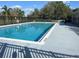 Enjoy the community pool with a safety fence and a view of the palm trees at 2320 Whispering Trails Pl, Winter Haven, FL 33884