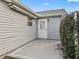 Back porch with a door and a small patch of plants at 2444 Merida Cir, The Villages, FL 32162